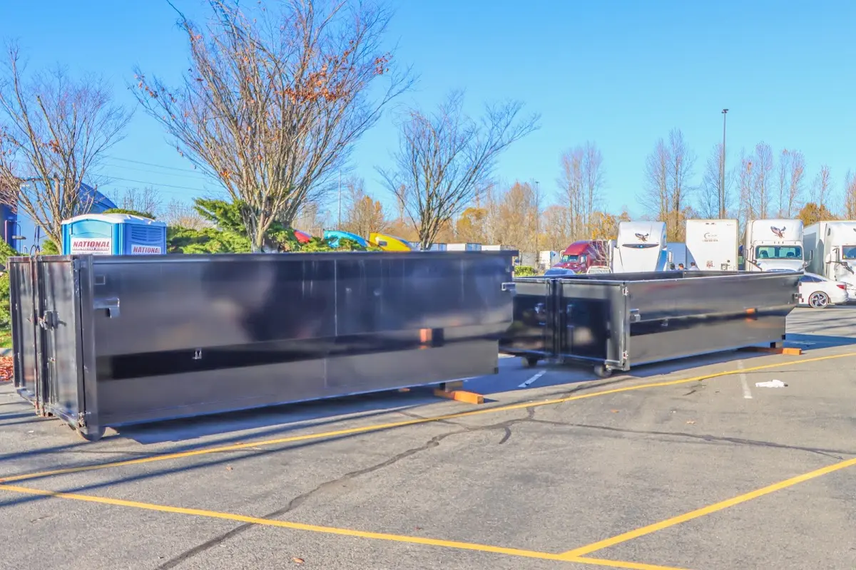 Professional dumpster rental service with roll-off container on residential driveway in Kuna